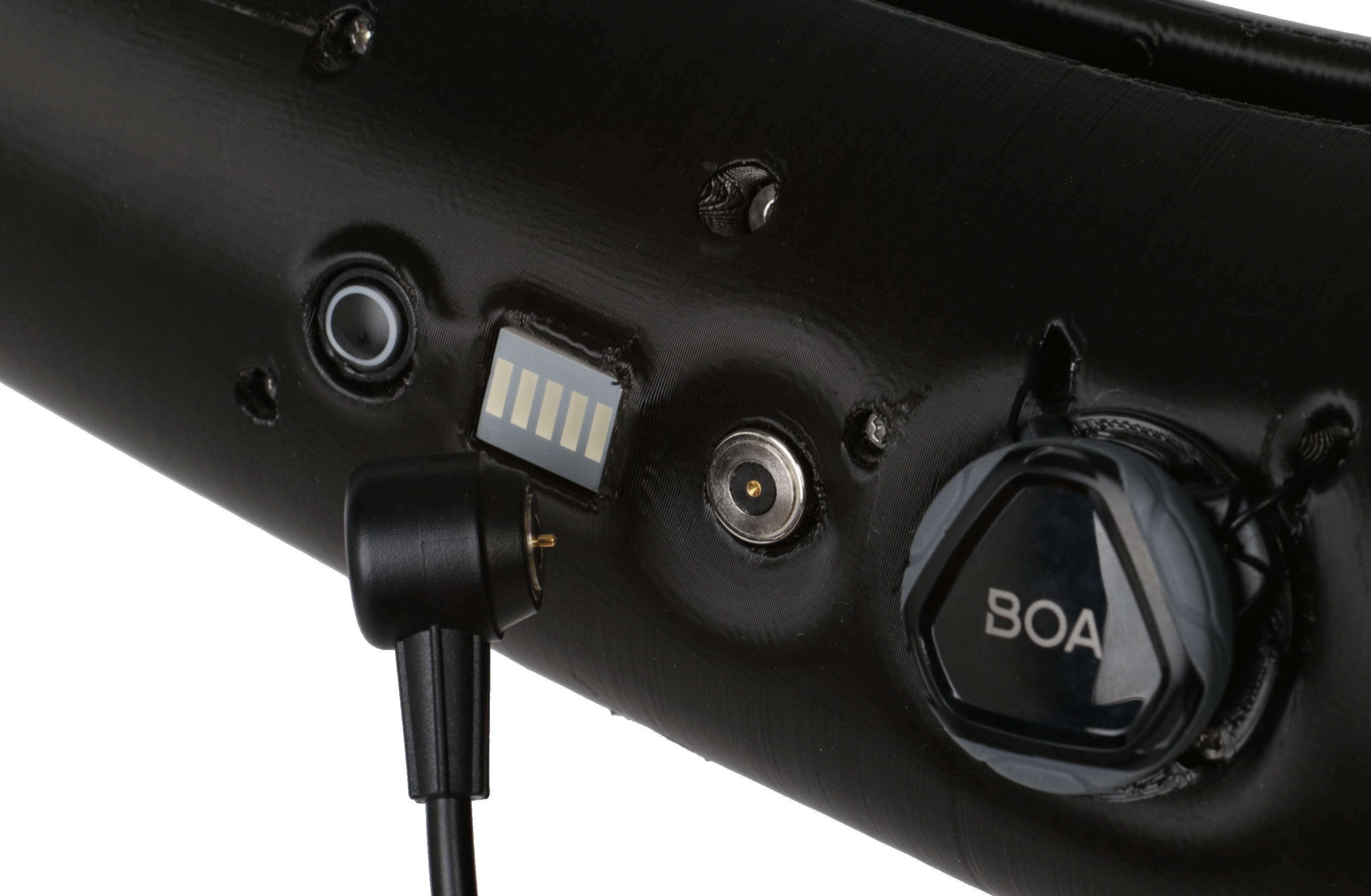 Magnetic charging connector attached to the charging contacts on a black prosthetic socket